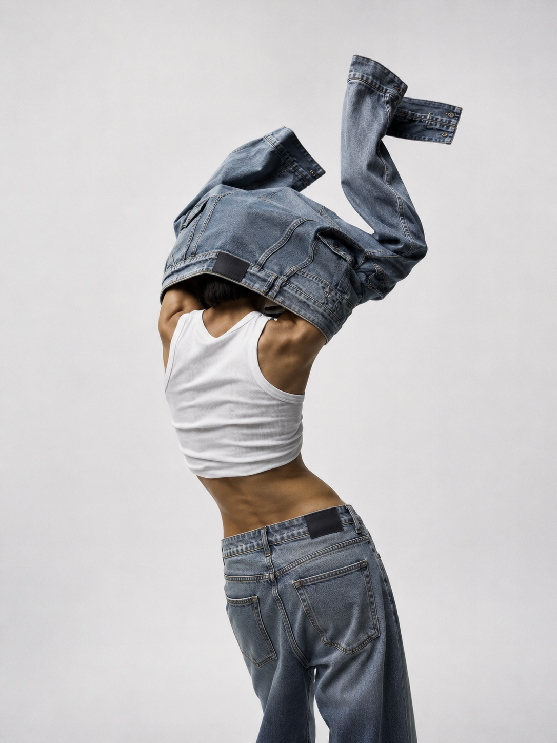 Denim jacket pulled up over the head, seen from behind