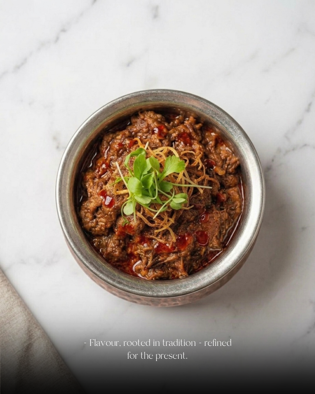 Slow-cooked spiced meat in a steel bowl