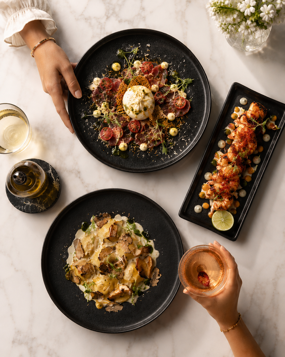 Overhead black-plate spread with burrata and prawns